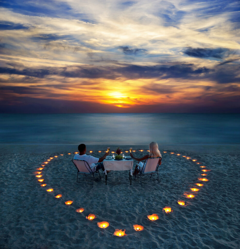 young couple share a romantic dinner on the beach